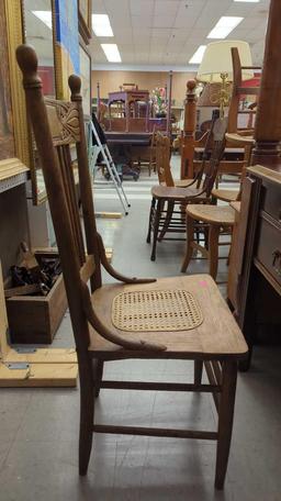 EARLY STYLE WOODEN PRESS BACK DINING CHAIR WITH A WICKER BOTTOM MEASURES APPROXIMATELY 17 IN X 15 IN