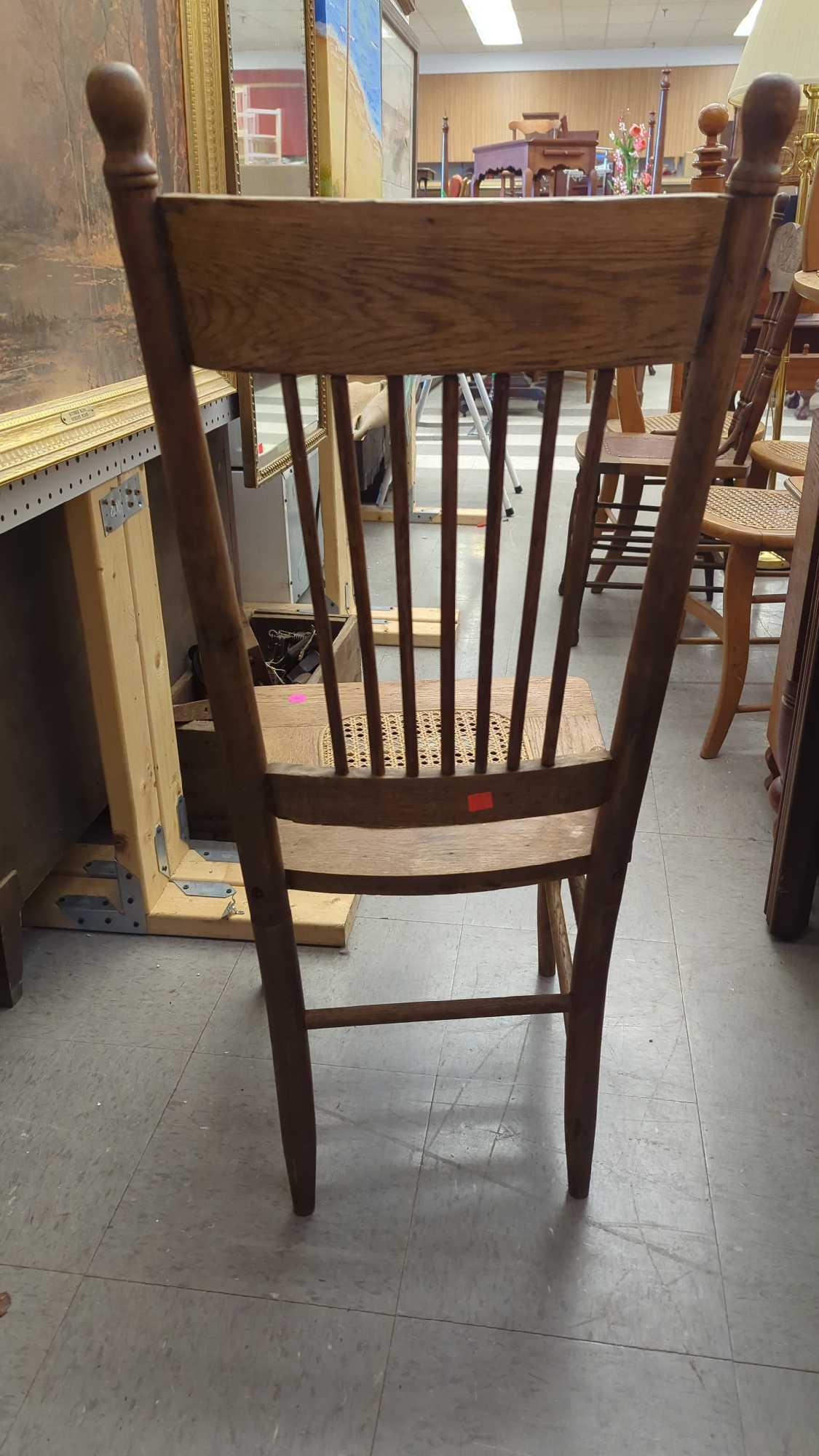 EARLY STYLE WOODEN PRESS BACK DINING CHAIR WITH A WICKER BOTTOM MEASURES APPROXIMATELY 17 IN X 15 IN
