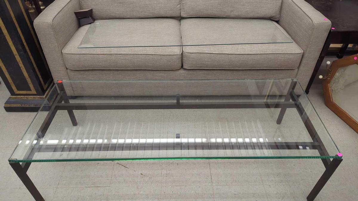 METAL AND GLASS TOP COFFEE TABLE MEASURES APPROXIMATELY 60 IN X 24 IN X 16 IN.