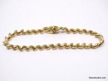 UNIQUE 14K YELLOW GOLD TWISTED LINK BRACELET. MARKED "14K F". IT MEASURES APPROX. 7" LONG & WEIGHS