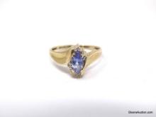 VINTAGE 10K YELLOW GOLD RING FEATURING A LOVELY MARQUISE CUT TANZANITE GEMSTONE, ACCENTED WITH SMALL