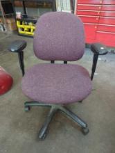 (WS) BURGUNDY UPHOLSTERED ROLLING OFFICE CHAIR WITH ARMS. IT MEASURES APPROX. 26-1/2"W X 22-1/2"D X