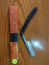 Sterling Company vintage straight razor with black handle. Comes with original box. Blade measures