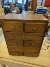 Medium brown colored on the dresser. Jewelry chest with eight doors and gold toned knobs Dimensions