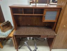 Medium brown colored wooden desk with granite style top with one cabinet, 3 upper shelves, 1 drawer
