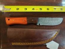 HANDMADE DAMASCUS DROP POINT KNIFE WITH ORANGE AND BROWN WOOD HANDLE. BLADE MEASURES 3.75". COMES