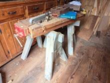 (SHED 2) LOT TO INCLUDE (2) WOODEN SAW HORSES, WOODEN PLANK TOP WITH AN ATTACHED CLAMP, & OTHER