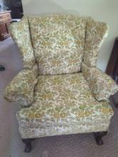 (LR) CREAM, GREEN AND GOLD TONED FLORAL WINGBACK CHAIR. SITS ON WOOD CLAW STYLE LEGS. MEASURES