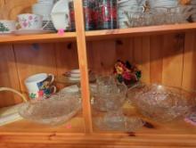 (KIT) CONTENTS OF BOTTOM SHELF OF CORNER CABINET TO INCLUDE: A YELLOW KNIT NAPKIN HOLDER, GLASS CAKE