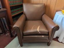 (OFC2) VINTAGE BROWN LEATHER SINGLE CUSHION ARM CHAIR WITH WOODEN LEGS AND NAIL HEAD TRIM DETAILING.