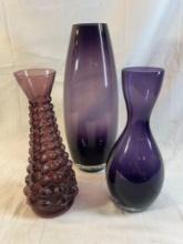 Lot of 3 glass purple vases. Largest vase is approx. 14"H