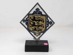 (LR) VINTAGE TRIANGULAR PAINTING ON GLASS DEPICTING A THREE LION CREST. THE GLASS IS FRAMED IN A