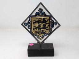 (LR) VINTAGE TRIANGULAR PAINTING ON GLASS DEPICTING A THREE LION CREST. THE GLASS IS FRAMED IN A