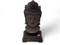 (LR) VINTAGE COMPOSITION BUDDHA HEAD DISPLAYED ON A SQUARE DETAILED BASE. IT MEASURES APPROX.