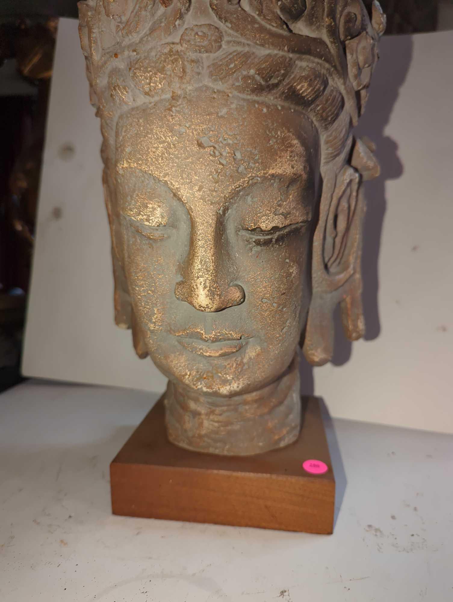 (LR) CAST CERAMIC HEAD OF ENTHRONED BUDDAH, ON WOOD BASE, SIGNED AUSM PROD, APPEARS TO BE IN GOOD