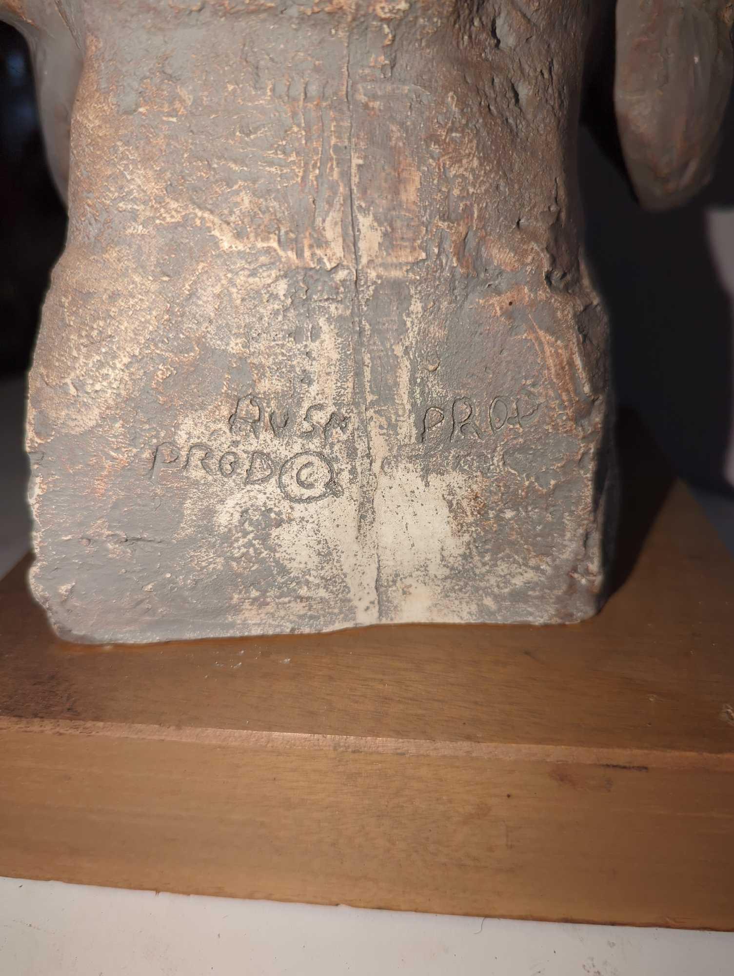 (LR) CAST CERAMIC HEAD OF ENTHRONED BUDDAH, ON WOOD BASE, SIGNED AUSM PROD, APPEARS TO BE IN GOOD