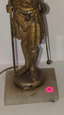 (FOY) ANTIQUE METAL ON WHITE STONE TABLE LAMP, FIGURINE OF A SPELTER SOLDIER HOLDING A BANNER, HAS A