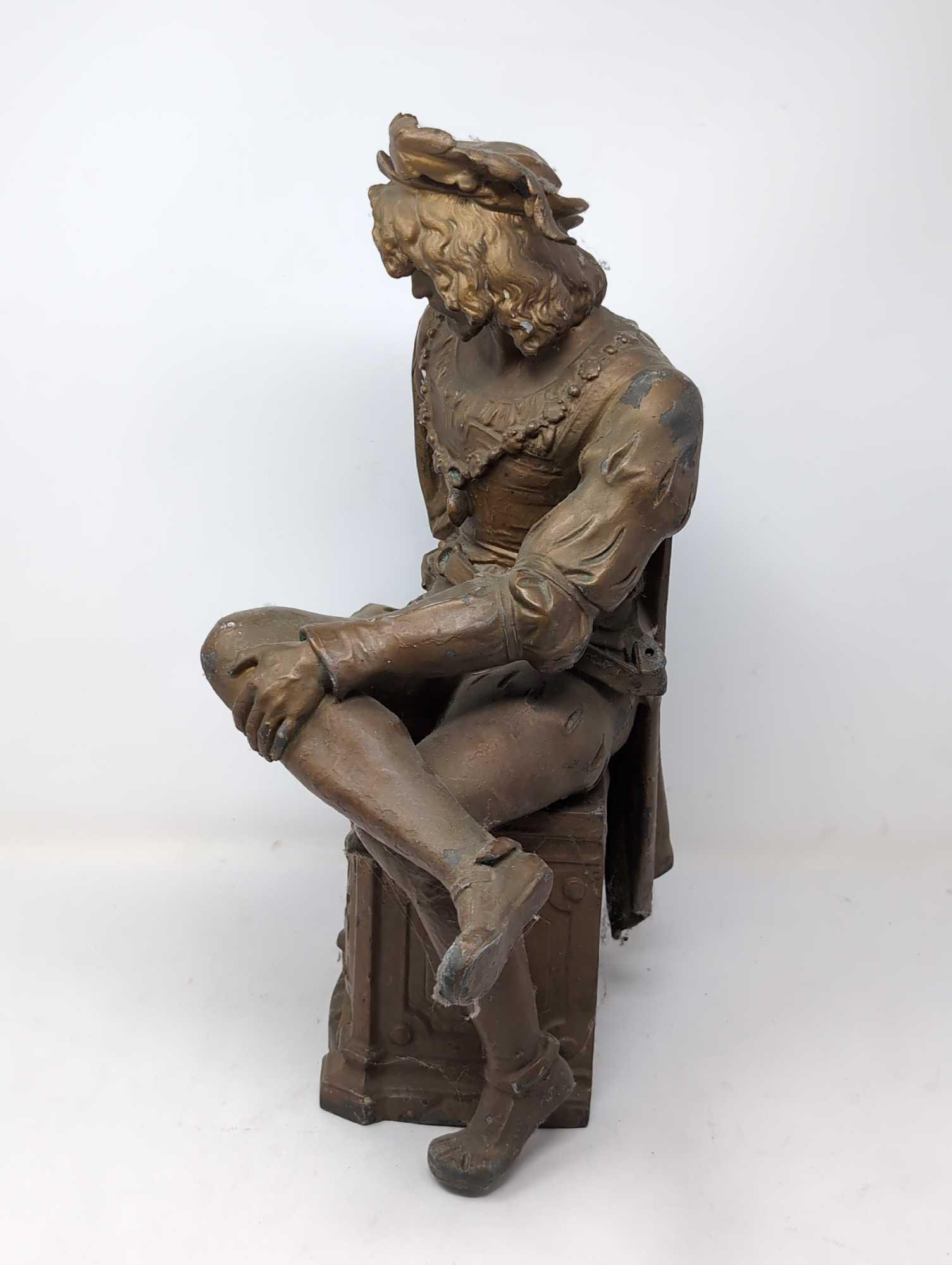 (FOYER) ANTIQUE VICTORIAN SPELTER STATUE DEPICTING AN ENGLISHMAN SITTING ON AN ORNATE BAT DETAILED