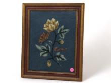 (FOYER) VINTAGE HAND STITCHED NEEDLEPOINT ART DEPICTING A SINGLE FLOWER WITH A BUTTERFLY AND SLUG.