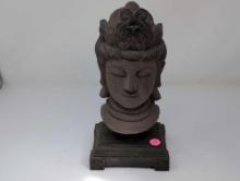 (LR) VINTAGE COMPOSITION BUDDHA HEAD DISPLAYED ON A SQUARE DETAILED BASE. IT MEASURES APPROX.