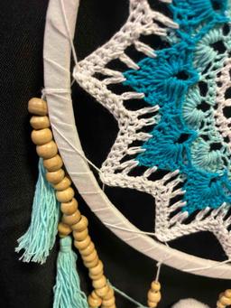 Crochet dream catcher. Turquoise, cream with wooden beads and pom pom accents. Hoop is 10", entire