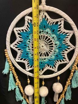 Crochet dream catcher. Turquoise, cream with wooden beads and pom pom accents. Hoop is 10", entire