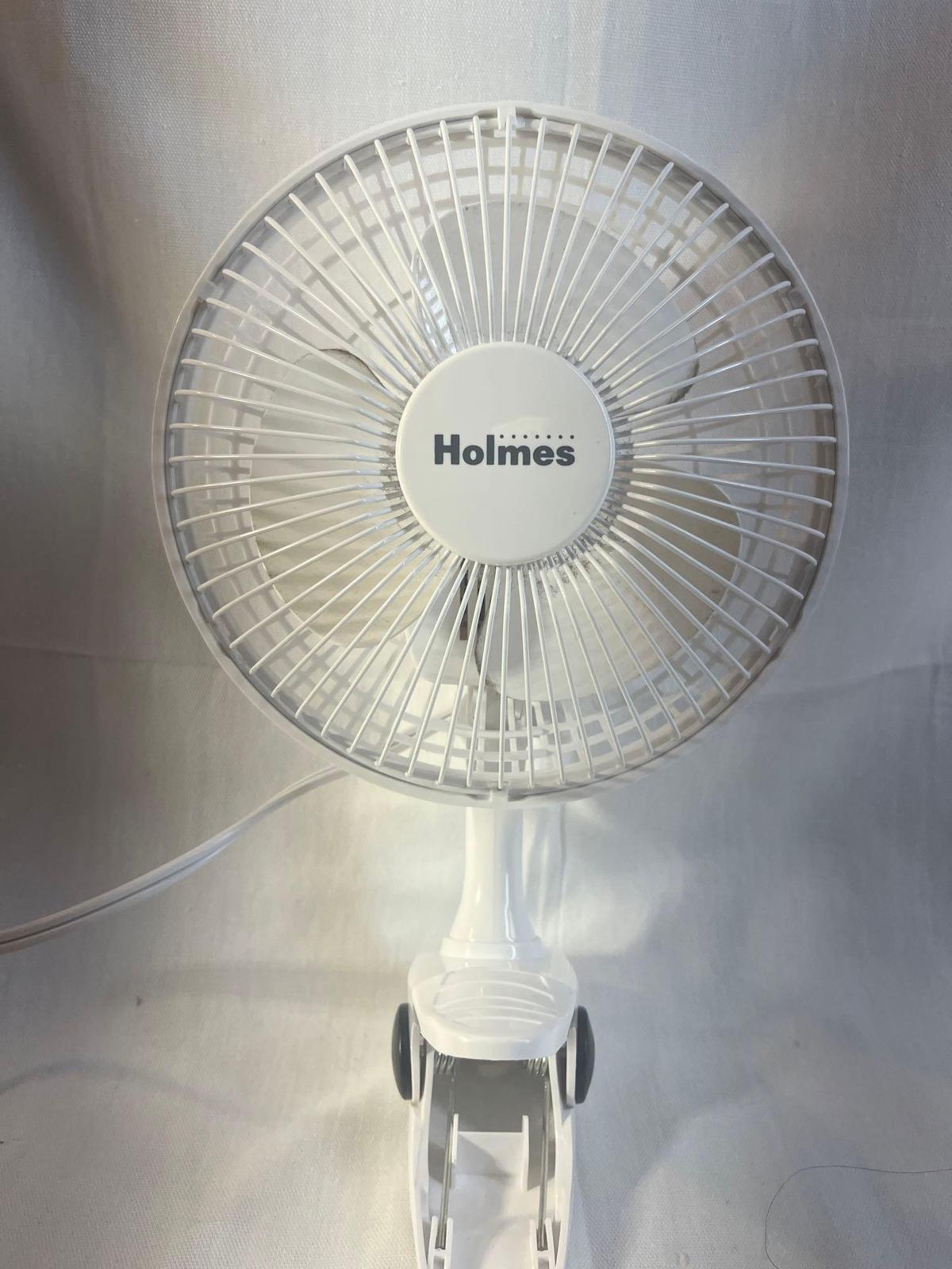 Holmes, portable plug-in fan with clip on base.
