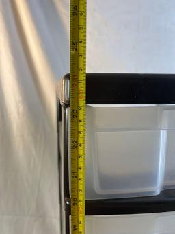 Black and clear plastic storage container with drawers. 25" tall.