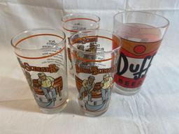 Drinking glass lot: three Jack Daniels Bung Slinger glasses, one Duff Simpsons glass