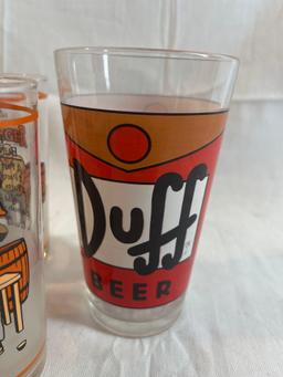 Drinking glass lot: three Jack Daniels Bung Slinger glasses, one Duff Simpsons glass