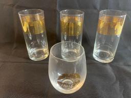 Set of glassware. Clear glass with gold accents.