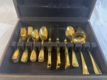 Flatware serving set. Gold color in wooden box....