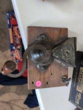 (LR) ANTIQUE CRANK COFFE GRINDER ATTACHED TO A WOODEN WALL PLAQUE. 8" X 10".