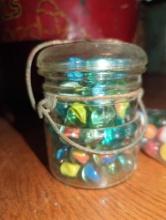 (DR) LOT OF ASSORTED CONTAINERS CONTAINING ASSORTED TYPES OF MARBLES, WHAT YOU SEE IN THE PHOTOS IS