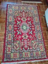 (KIT) HANDWOVEN AREA RUG WITH COLORS OF RED, BLACK, WHITE, AND GREY, HAS END FRINGE IN COLOR WHITE,
