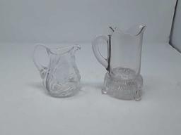 2 CUT GLASS SMALL PITCHERS 1-FOOTED BOTTOM