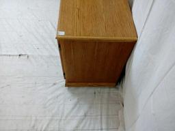 Light oak TV stand on casters