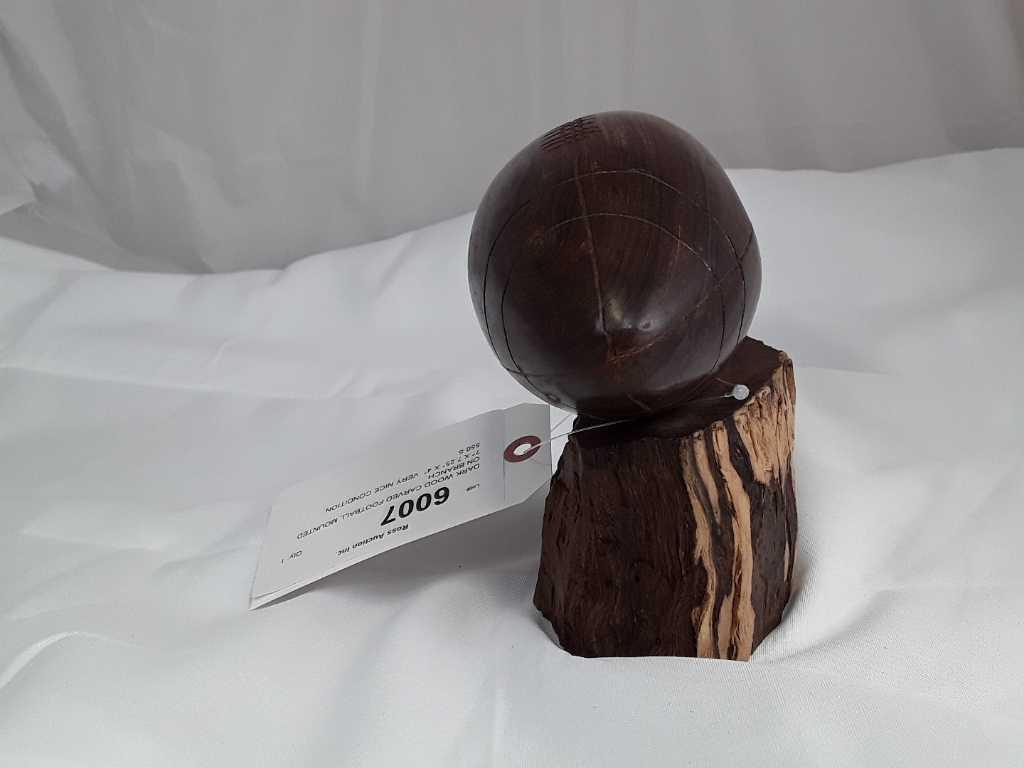 DARK WOOD CARVED FOOTBALL MOUNTED ON BRANCH