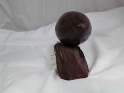 DARK WOOD CARVED FOOTBALL MOUNTED ON BRANCH
