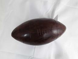 DARK WOOD CARVED FOOTBALL MOUNTED ON BRANCH