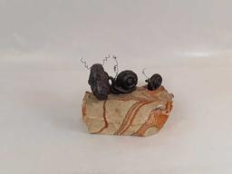 3 BRONZE SNAILS MOUNTED ON SANDSTONE