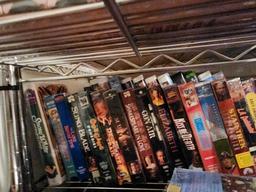 Assorted VHS Tapes on Top Three Shelves