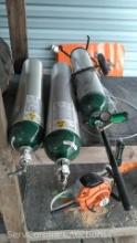 Lot on Shelf of 3 Compressed USP Oxygen Tanks with 1 Oxygen Dolly