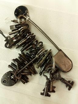 ASSORTED VINTAGE SKELETON KEYS AND LOCKS ON LARGE SAFETY PIN