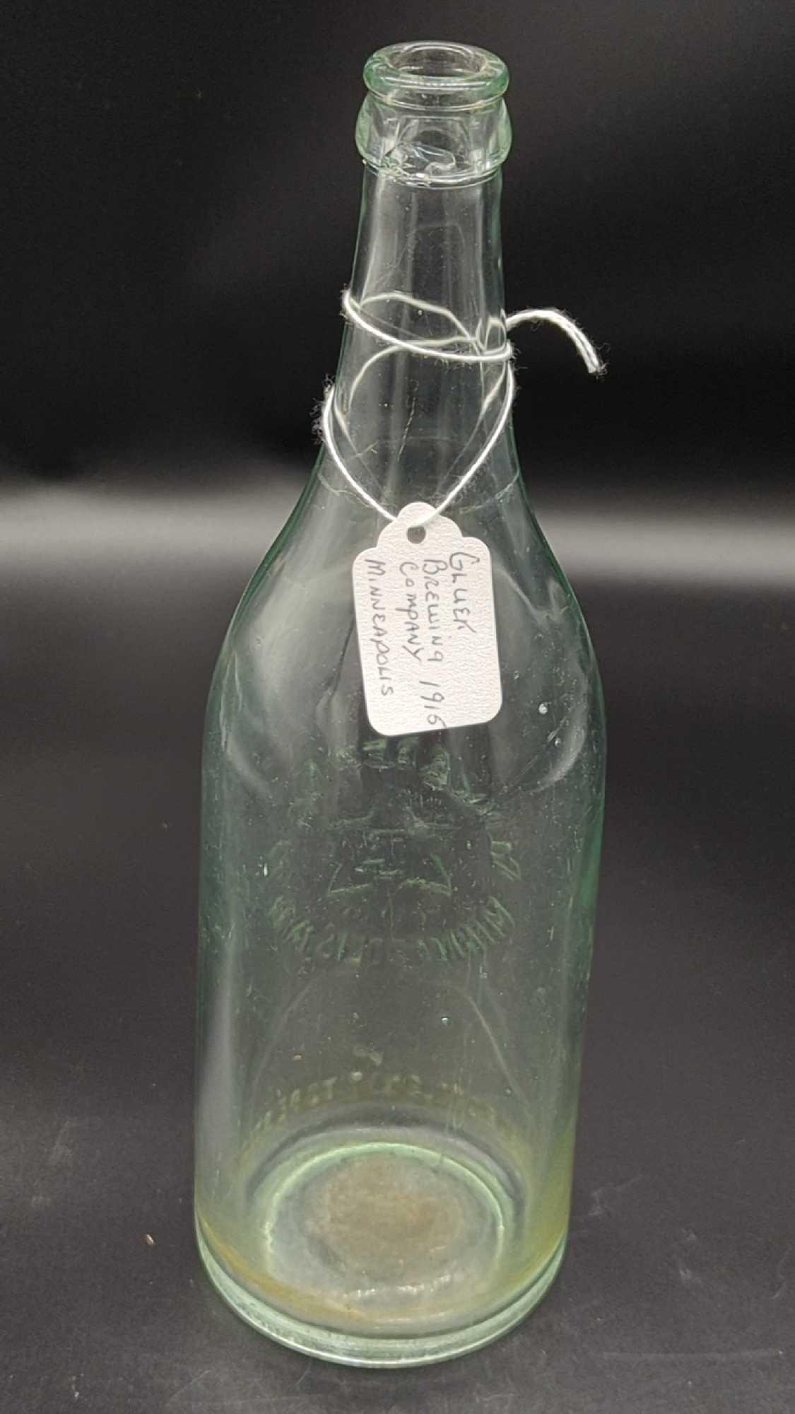 GLUEK BREWING CO. MINNEAPOLIS, MINN 11.5" PRE PROHIBITION BOTTLE 1915 - CRACK ON OUTSIDE OF MOUTH