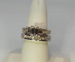 LADIES 14K W/G  .1CT EMERALD CUT CENTER DIAMOND ONE WITH EMERALD CUT SIDE DIAMONDS AND CHANNEL  SET