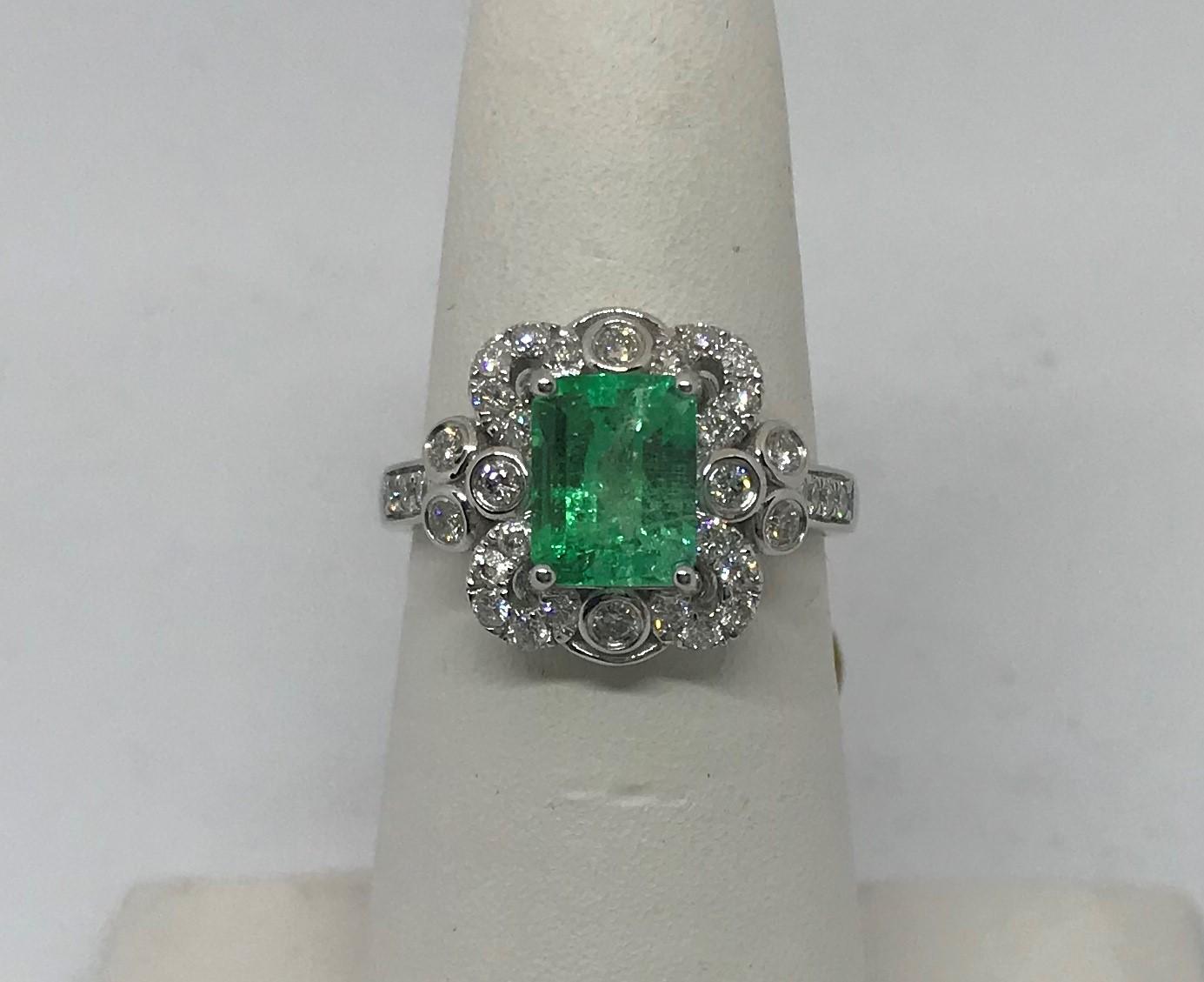 LADIES 18K W/G 1.57CT EMERALD CUT EMERALD CENTER STONE SURROUNDED WITH .56CT T.W. DIAMOND RING