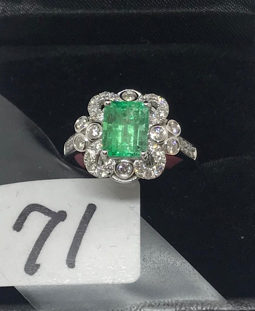 LADIES 18K W/G 1.57CT EMERALD CUT EMERALD CENTER STONE SURROUNDED WITH .56CT T.W. DIAMOND RING