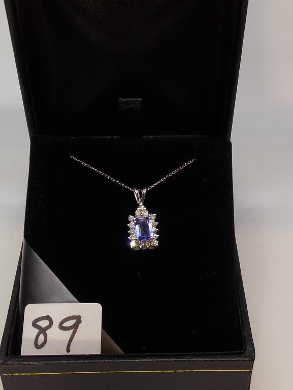 LADIES 14K W/G  .89CT EMERALD CUT TANZ CENTER STONE.44CT T.W. DIAMOND AROUND PENDANT 2.7GR