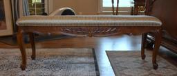 Elegant Carved Wooden Bench with Neutral Upholstered Seat